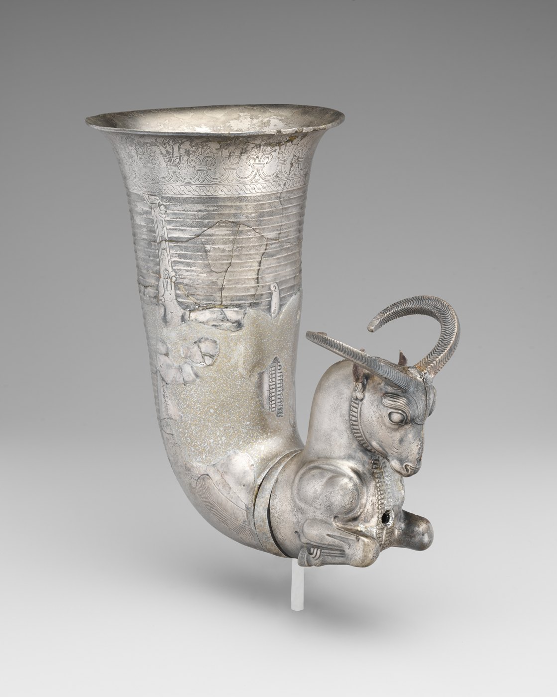 A silver horn-shaped drinking vessel ending in a kneeling animal.