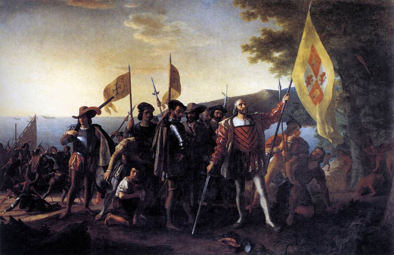 A large historical painting of Columbus raising a flag on a shore with his crew.