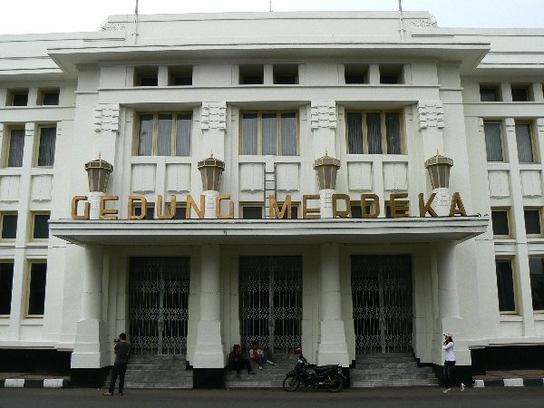 The curved white facade of Gedung Merdeka in Bandung