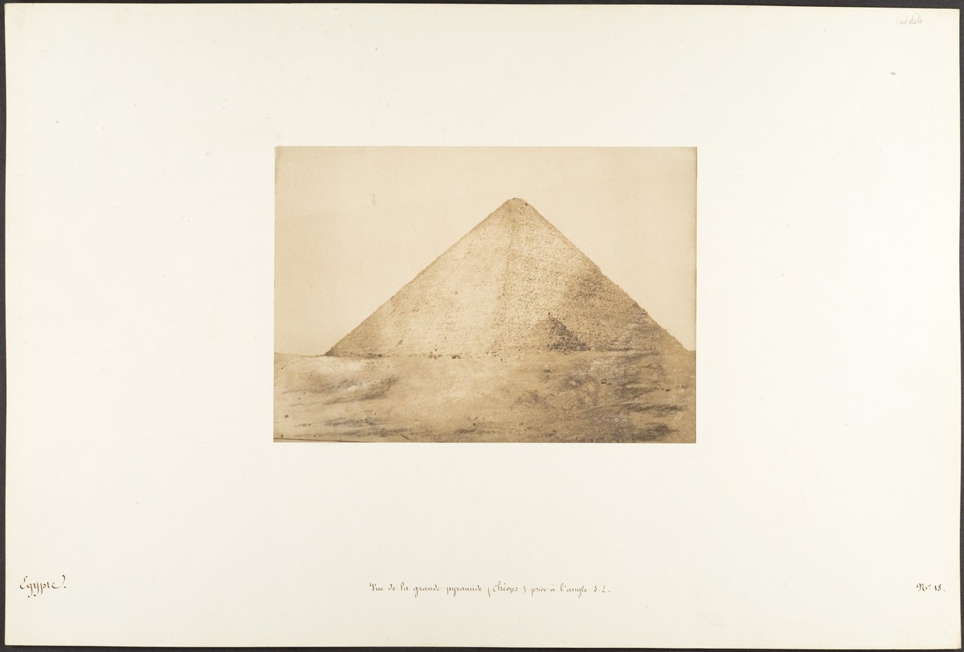An early photograph of the Great Pyramid rising from a rocky foreground.