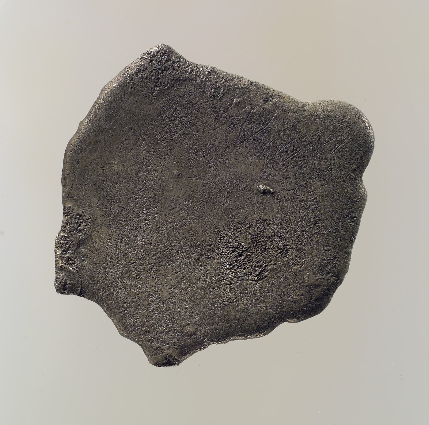 A metal ingot bearing Hittite hieroglyphic marks.