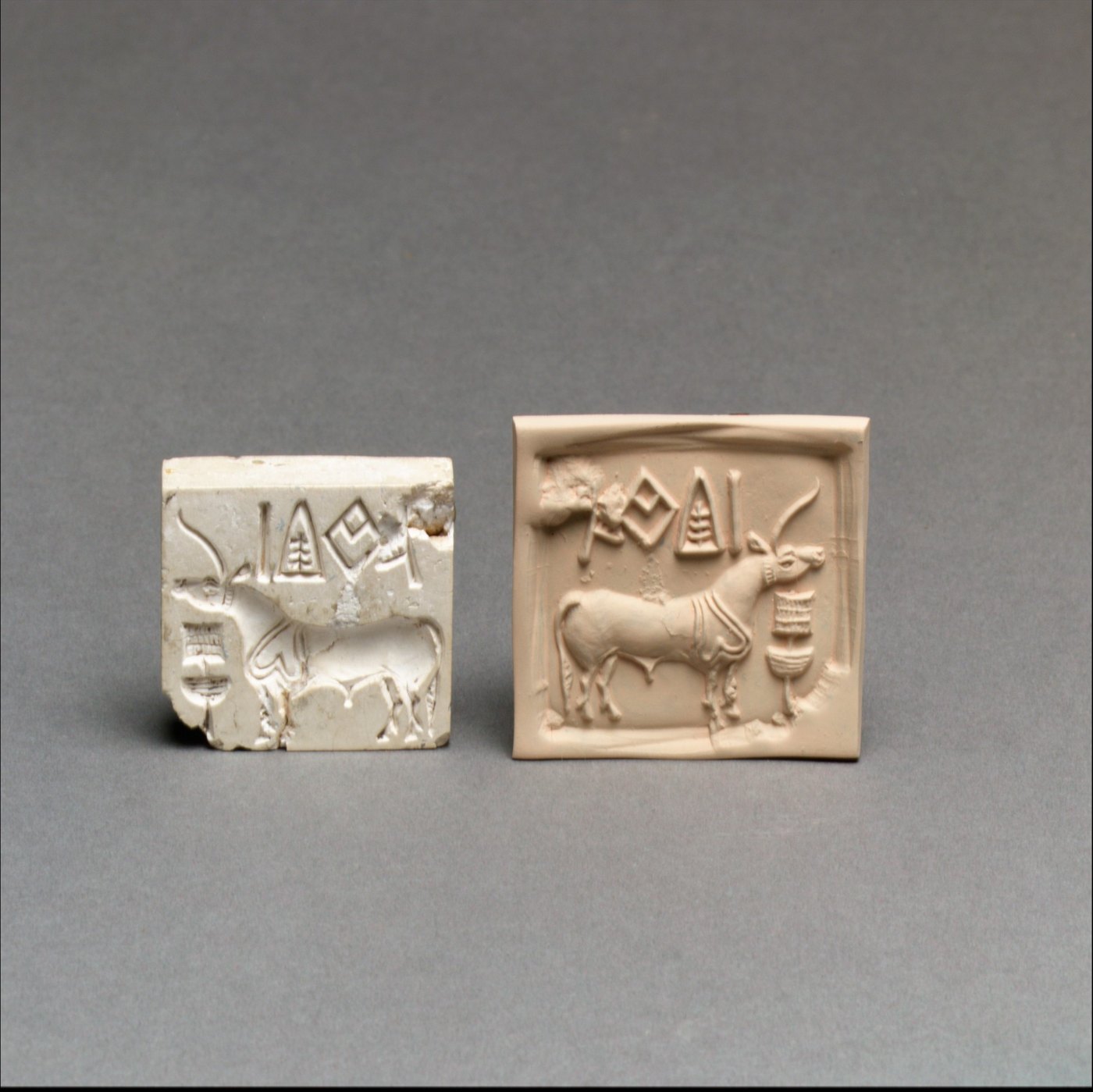 A square seal and impression showing a horned animal and signs.