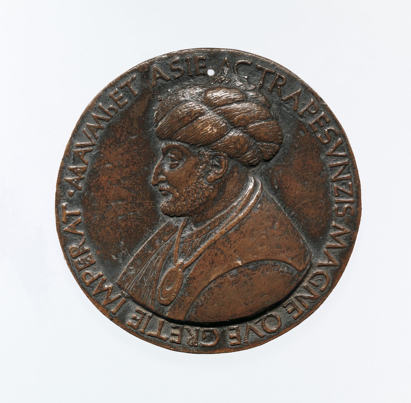 A circular bronze medal with a turbaned ruler in profile.
