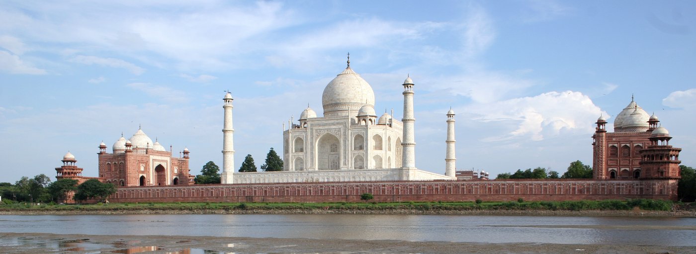 The Taj Mahal mausoleum, minarets and adjacent red sandstone buildings